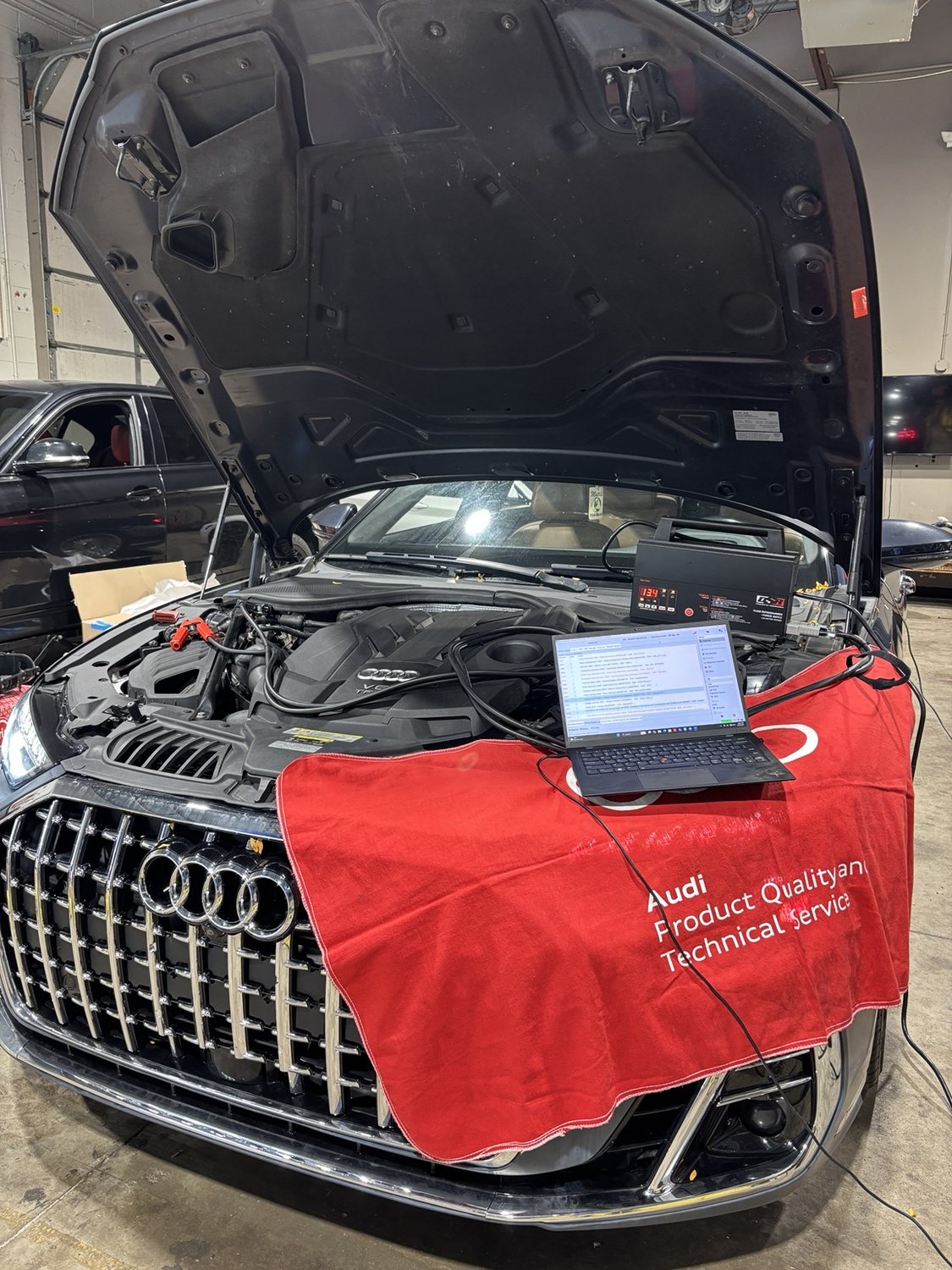 Audi undergoing programming with diagnostic laptop and service equipment
